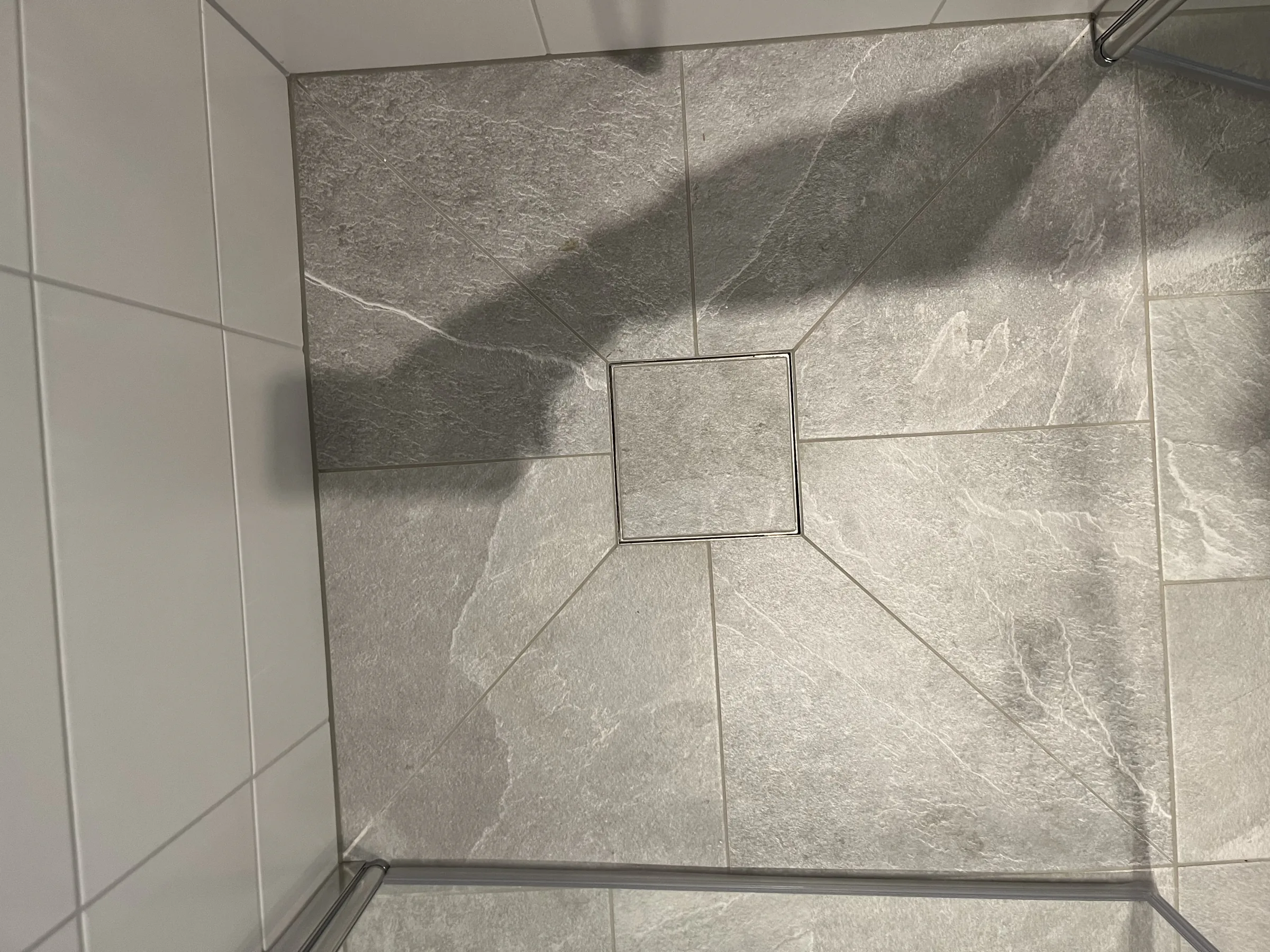 Detaljbild av golvbrunnen och plattsättningen